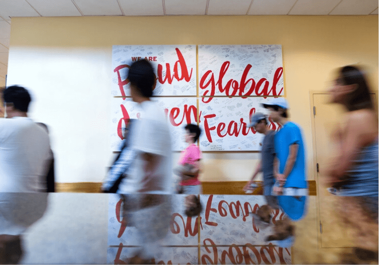 Students walking in front of fearless signage